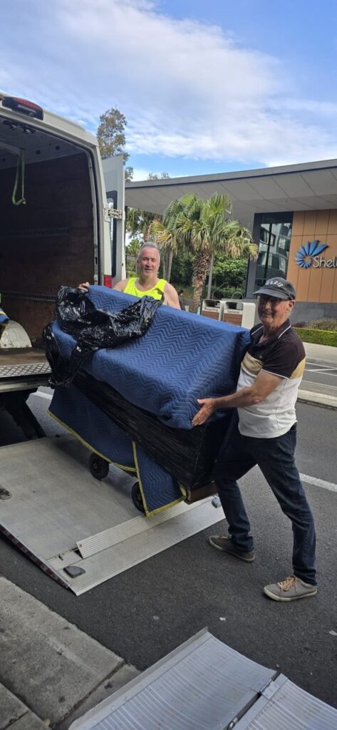 A protected piano being carefully loaded for safe transport